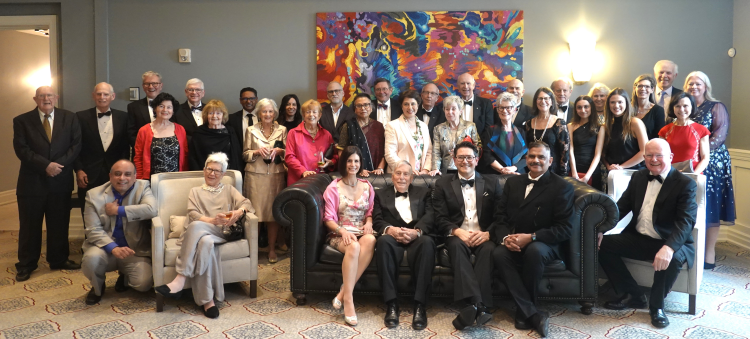 A large group of men and women in formal wear